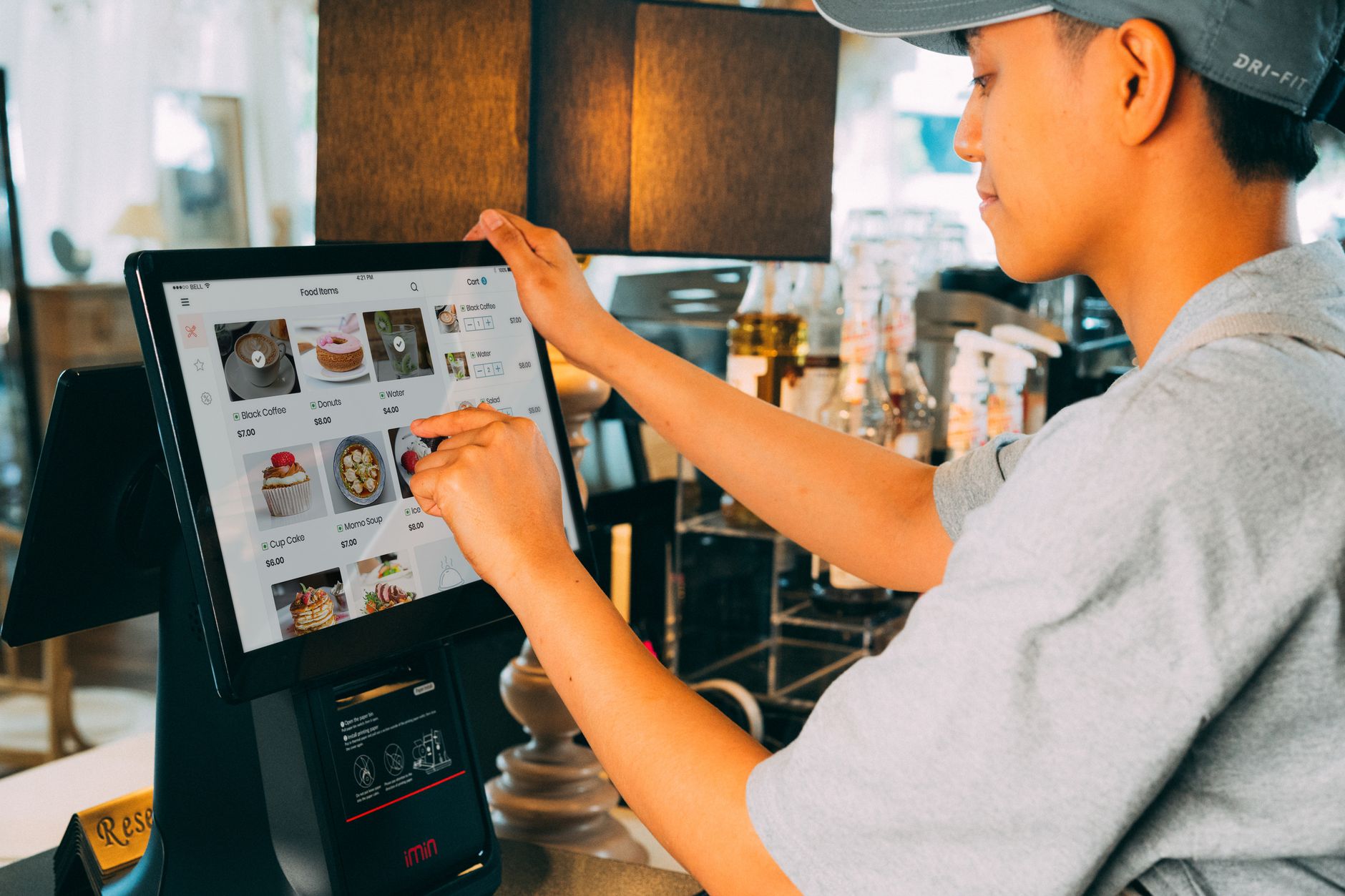 Cashier taking an order on a Bontado POS touchscreen